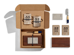 The Cheese Tasting Set includes cheese tasting journals, a knife, a cutting board and more.