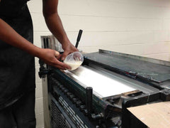 A small amount of milk being added to 33 Cheeses on press
