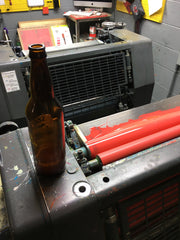 Adding a little home-pressed cider to the ink on press.