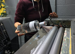 A little bit of gin being added to the ink used on the cover of my martini journal
